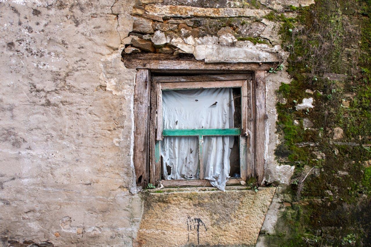 windows with tattered curtains.