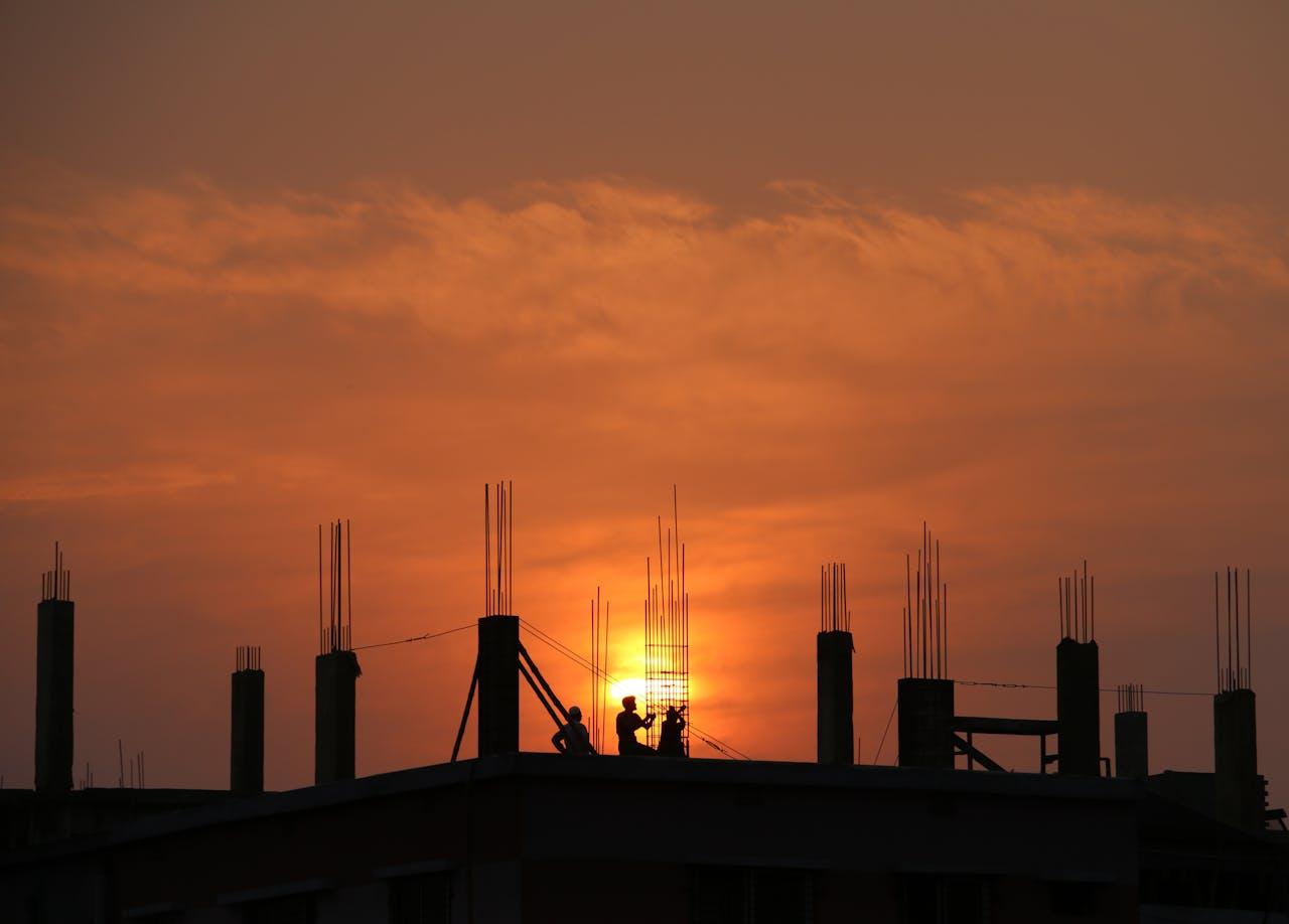 Arbeiter silhouettiert gegen Sonnenuntergang.