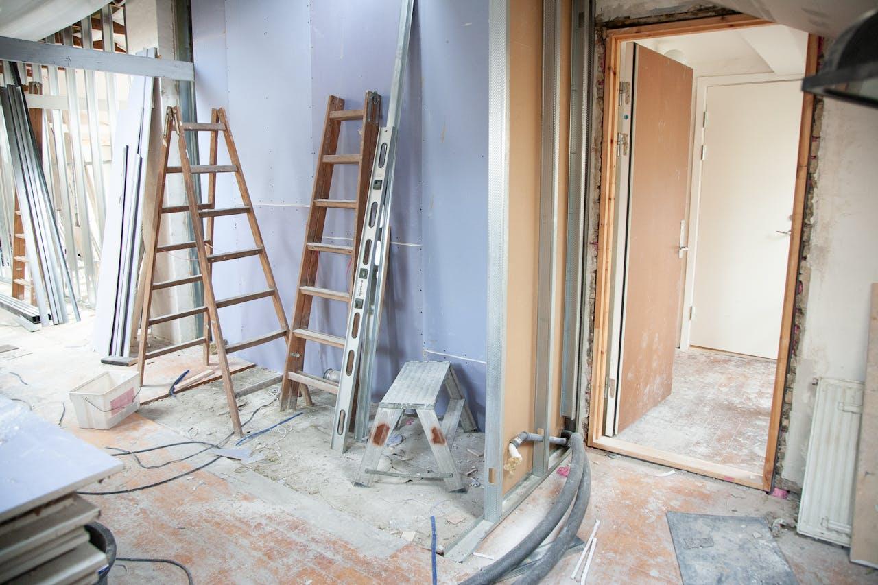 Construction site with ladders and door.